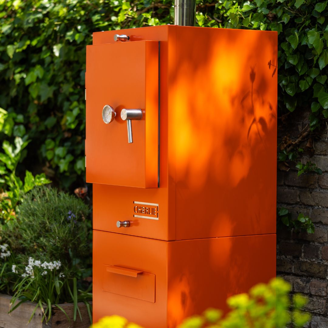 Charlie Charcoal Oven in Saffron, garden lifestyle